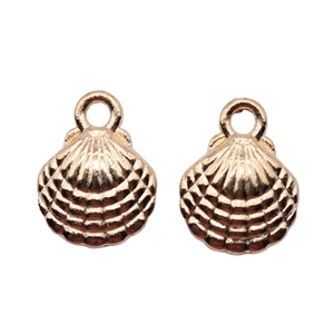 Detail of two gold scallop shell pendants with realistic texture and top loops for DIY
