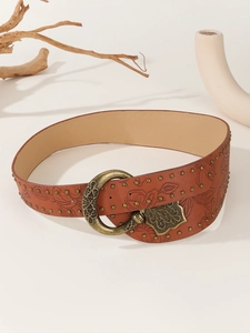 Detail of vintage brown leather belt with floral embossing and bronze metal buckle