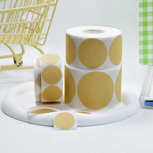 Macro shot of round kraft paper adhesive labels on a roll for item categorization