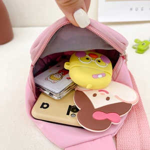 Pink cartoon bear crossbody bag for kids showing inner capacity with daily essentials