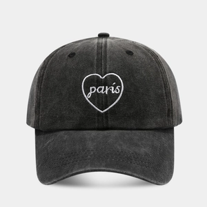 Close-up of Paris heart embroidery on a charcoal grey washed cotton baseball cap
