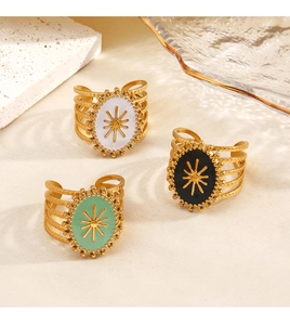 Detailed view of three vintage-style resin rings with sunburst patterns on stone props