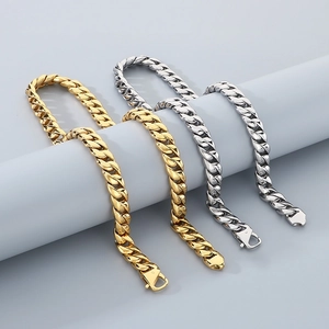 Detail view of four 12mm polished Cuban link bracelets in gold and silver on a display stand