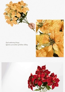 Detail of red and gold artificial poinsettia flowers with glittered petal edges