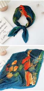 Detail view of colorful pleated square silk scarf with abstract artistic floral print
