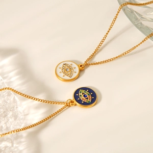 Detailed shot of evil eye necklaces in gold finish with white and blue enamel detail