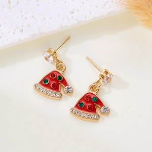 Detail of Christmas hat earrings with red enamel and green crystals on gold metal