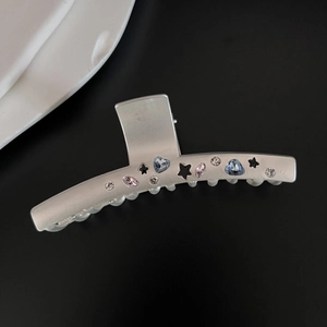 Detail of matte silver shark clip with blue heart and pink marquise zircon stones
