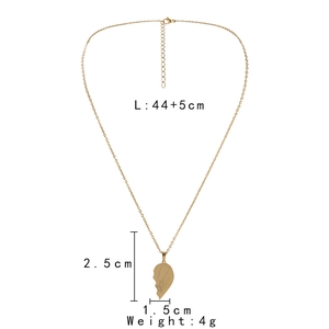 Detail view of gold heart necklace with hand-holding engraving and size measurements