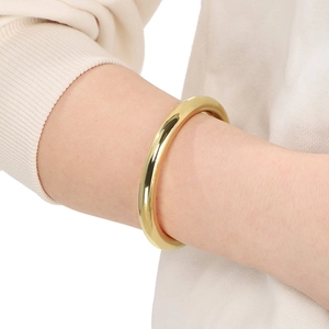 Minimalist 18K gold plated hollow C-shape cuff bracelet shown on wrist in classic style