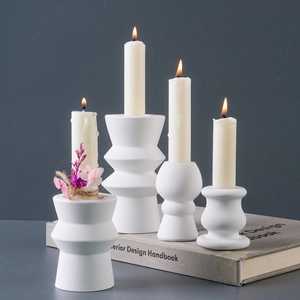 Set of four minimalist white geometric ceramic candle holders for pillar candles