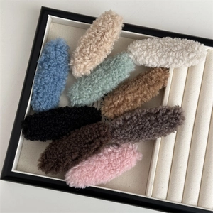 Collection of plush candy-colored autumn hair clips displayed on a velvet jewelry tray