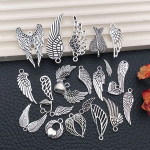 Detail of silver vintage angel wing alloy pendants with intricate feather texture for DIY craft