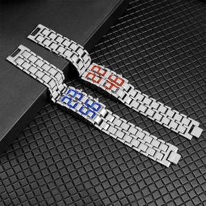 Close-up of silver steel LED watches with red and blue digital lights on black texture