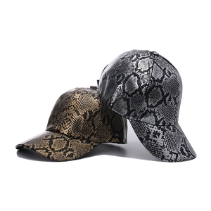 Golden and silver faux leather baseball caps with snakeskin pattern in high gloss finish