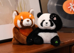 Detailed close-up of plush panda toy set with soft faux fur texture in cozy home setting