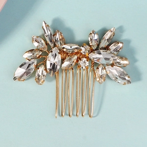 Detailed view of handmade golden bridal hair comb with navette and round rhinestones