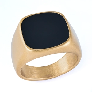 Close-up of golden stainless steel signet ring featuring a polished black square top