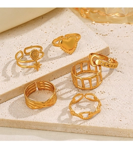 Detail of 18K gold plated celestial ring set featuring moon and star motifs on stone