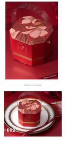 Macro detail of red octagonal wedding gift box with gold floral patterns and LOVE handle