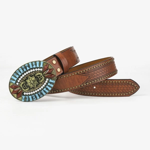 Detailed close-up of bohemian leather belt with turquoise buckle and floral patterns