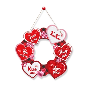 Macro shot of Valentine heart wreath with XOXO and Love phrases on red plaid base