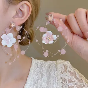 Pink crystal flower hoop earrings featuring delicate beads and romantic floral accents
