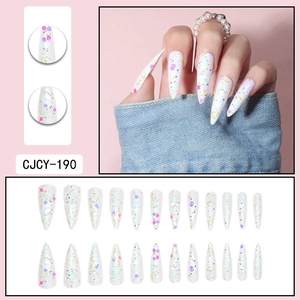 Detailed view of long stiletto press-on nails with colorful sequins and shiny glitter finish