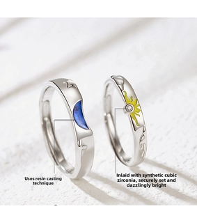 Detail of adjustable sun and moon couple rings with enamel inlay and cubic zirconia