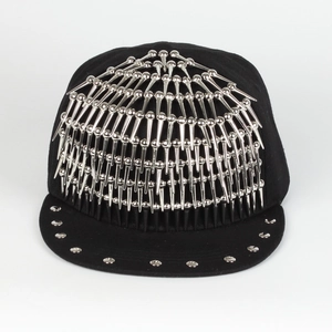 Detailed close-up of a black hip-hop snapback hat with metallic silver punk rivets and spikes