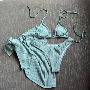 Mint green three-piece bikini set with textured fabric and matching sheer sarong wrap