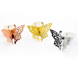 Detail of laser-cut butterfly napkin rings in gold, rose gold, and silver finishes
