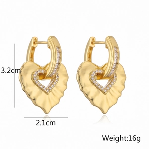 Detailed view of heart-shaped gold earrings with zircon stones and dimensions 3.2cm by 2.1cm
