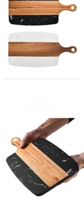 Detail of acacia wood and marble cutting board with handle and smooth hand-polished surface