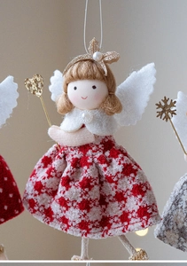 Detail of Christmas angel doll with red checkered dress, white wings and golden heart wand