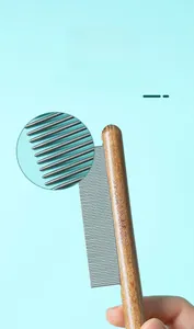 Dettaglio dei denti in metallo arrotondati di un pettine in legno per la cura del gatto