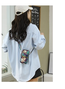 Floral print crossbody phone bag worn by a model in a casual setting