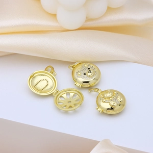 Gold plated bear locket necklace with zircons shown on silk with pearls decor