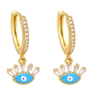 Detailed view of gold evil eye earrings featuring blue enamel and sparkling zircon stones