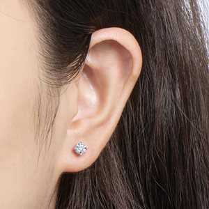 Macro detail of classic four-prong moissanite stud earring in 925 sterling silver