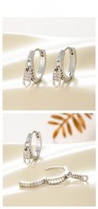 Detail of silver zipper earrings with micro-inlaid cubic zirconia on a minimalist base