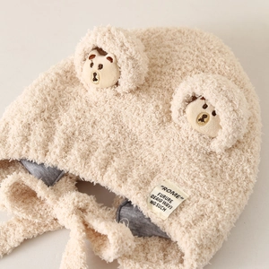 Cute beige winter plush baby hat with bear ears and chin straps for windproof warmth