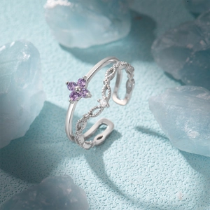 Detailed shot of S925 silver double-layered open ring with purple zircon flower on blue background