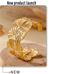 Detailed view of hollow ginkgo leaf stainless steel bangle with 18k gold plating