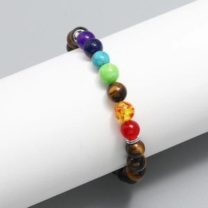 Seven Chakra energy beads bracelet with natural tiger eye stones on white stand