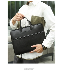 Man in a white shirt holding a sleek black waterproof laptop briefcase for business travel