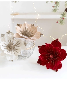 Close-up of sparkling velvet magnolia flowers in red, white and champagne for Christmas