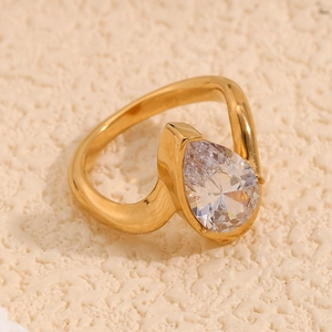 Macro shot of 18K gold plated ring featuring a pear-shaped white zircon in a bezel setting