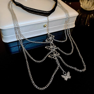 Detailed view of multilayer silver butterfly body chain with black lace choker accessory