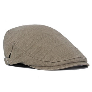 Detail of vintage brown cotton flat cap showing woven texture and adjustable metal buckle